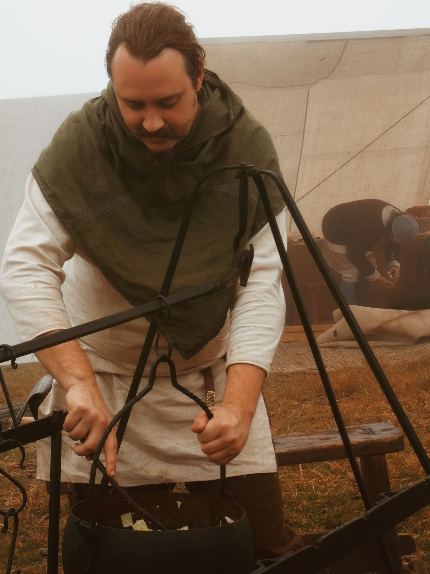 Huscarls members gathered around the camp fire at a living history encampment