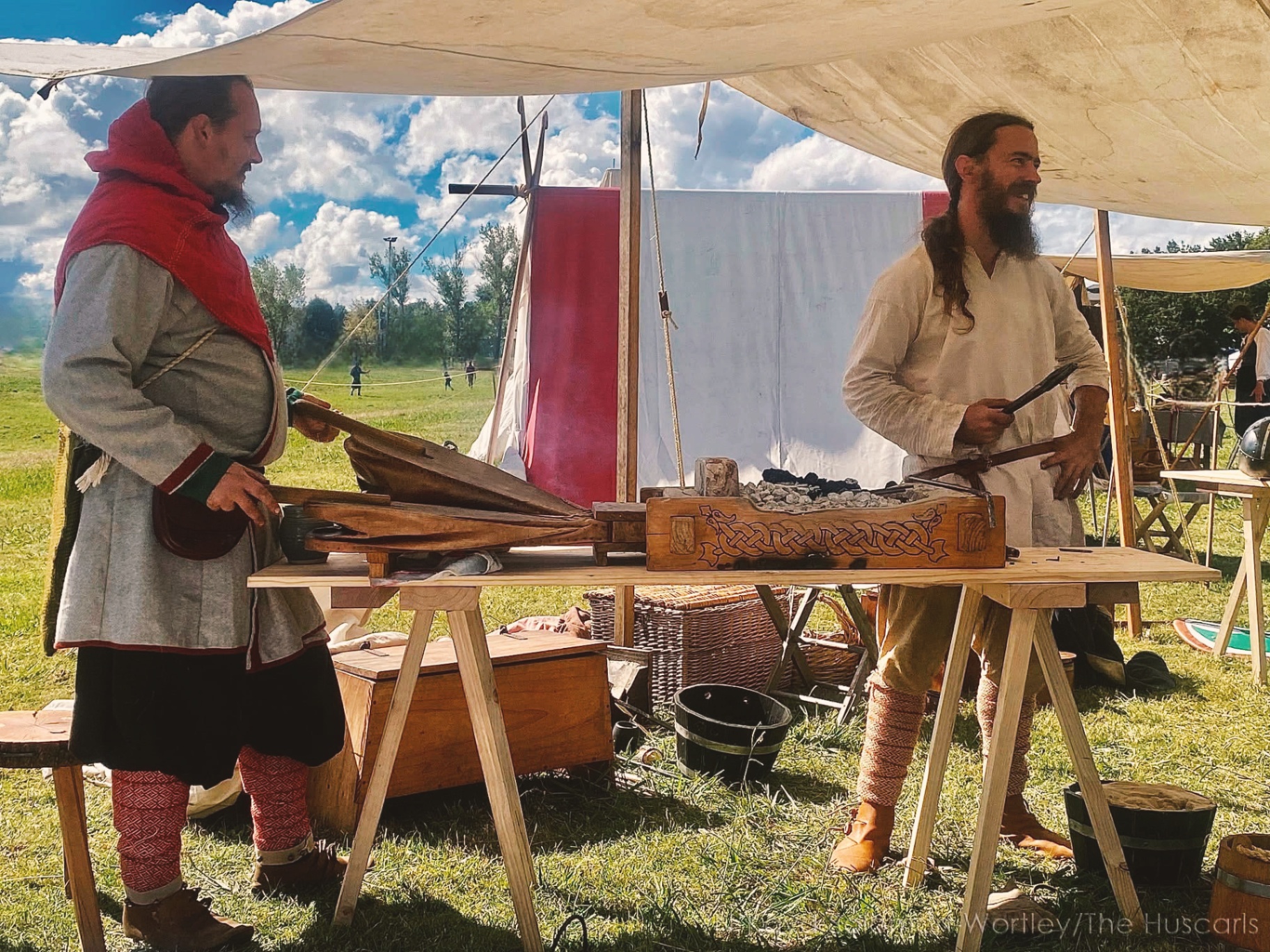 Huscarls members demonstrating period crafts at a living history encampment